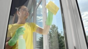 Squeegee being used from the top of a window downward.