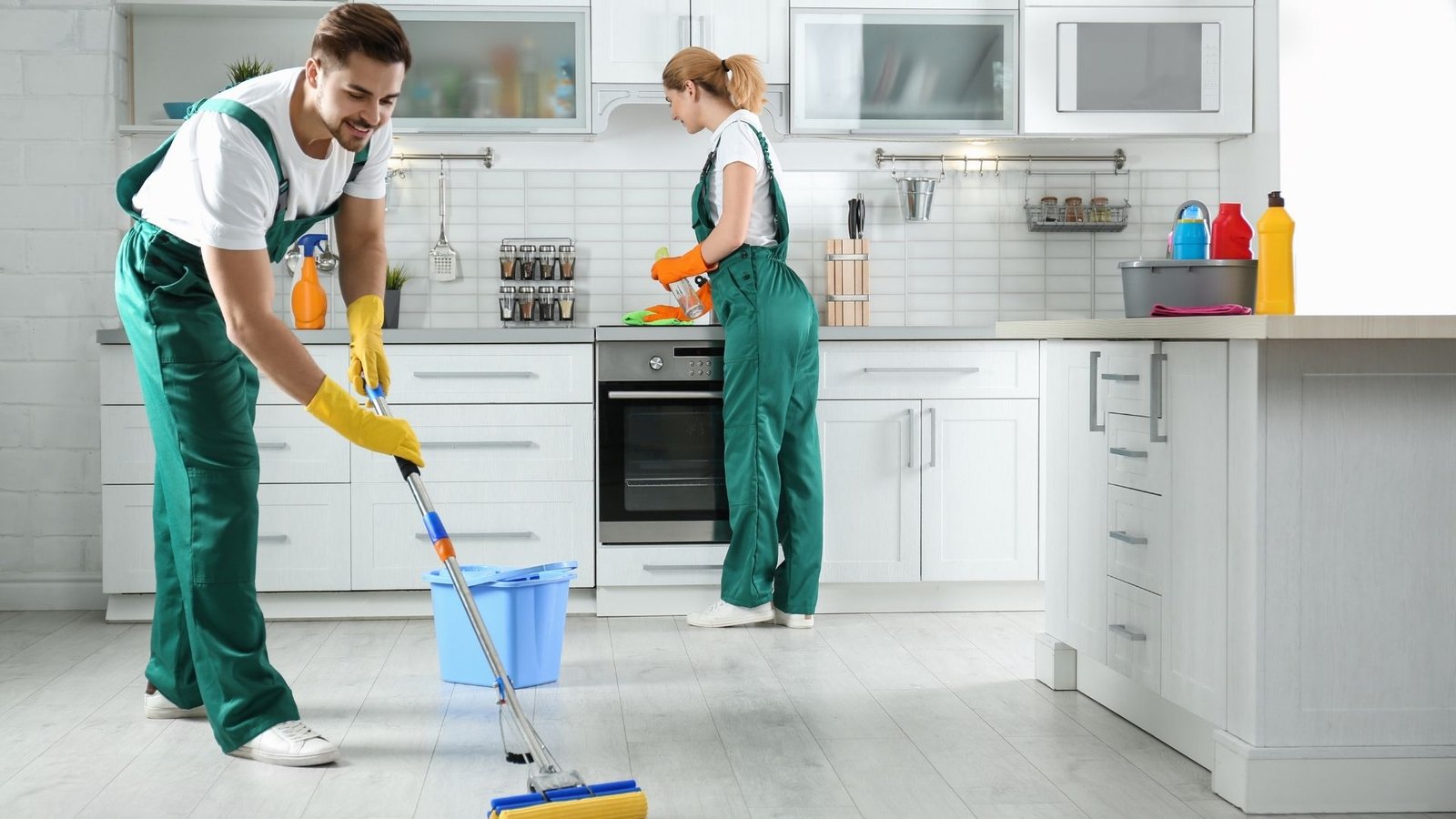 Kitchen floor being vacuumed before mopping.