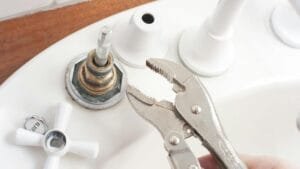 Traditional tap spindle and rubber washer during a DIY tap repair